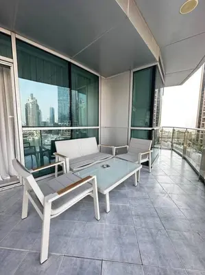a balcony with a table and chairs on a building at 2 BDR in Marina Terrace Dubai Marina in Dubai