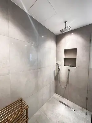 a bathroom with a shower stall and a bench at 2 BDR in Marina Terrace Dubai Marina in Dubai