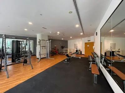 a gym with several treadmills and machines in a room at 2 BDR in Marina Terrace Dubai Marina in Dubai