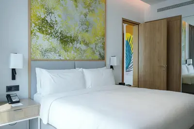 a bedroom with a white bed and a painting at Holiday Inn Dubai Business Bay by IHG in Dubai