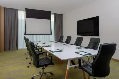 a conference room with a long table and chairs at Holiday Inn Dubai Business Bay by IHG in Dubai