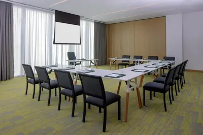 a conference room with a long table and chairs at Holiday Inn Dubai Business Bay by IHG in Dubai