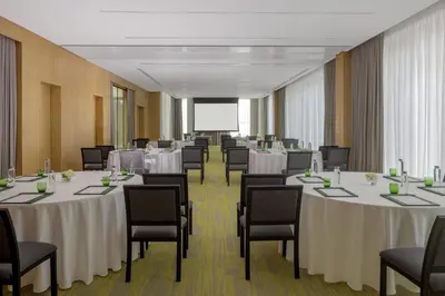 a conference room with white tables and chairs at Holiday Inn Dubai Business Bay by IHG in Dubai