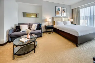 a hotel room with a bed and a couch at Magnificent apartment in Emaar Dubai Marina in Dubai