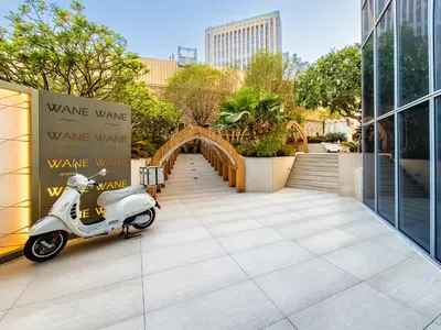 a scooter parked in front of a building with a bridge at Magnificent apartment in Emaar Dubai Marina in Dubai