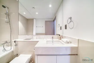 a white bathroom with a sink and a shower at Sumptuous 1BR at Act One Act Two Tower 1 Downtown Dubai by Deluxe Holiday Homes in Dubai