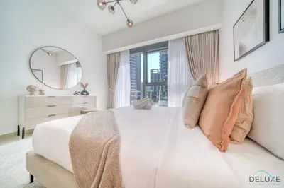 a bedroom with a white bed with a large window at Sumptuous 1BR at Act One Act Two Tower 1 Downtown Dubai by Deluxe Holiday Homes in Dubai