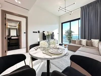 a living room with a couch and a table at Trophy Sunny Honey Suite Canal View & Infinty Pool in Dubai