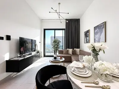 a living room with a table and a couch at Trophy Sunny Honey Suite Canal View & Infinty Pool in Dubai
