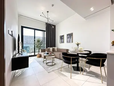 a living room with a couch and a table at Trophy Sunny Honey Suite Canal View & Infinty Pool in Dubai