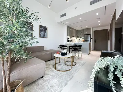 a living room with a couch and a table at Trophy Sunny Honey Suite Canal View & Infinty Pool in Dubai