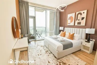 a bedroom with a large bed and a large window at 2ndHome - Amna Tower, Al Habtoor City in Dubai
