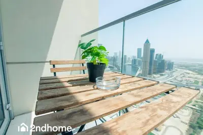 a wooden table with a plant on top of a building at 2ndHome - Amna Tower, Al Habtoor City in Dubai