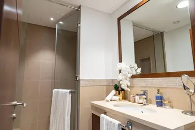 a bathroom with a sink and a mirror at Downtown 3BR Luxe, Burj & Fountain View Bliss Near Dubai Mall in Dubai
