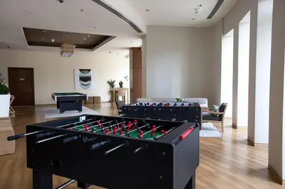 a living room with a large foosball table at Downtown 3BR Luxe, Burj & Fountain View Bliss Near Dubai Mall in Dubai