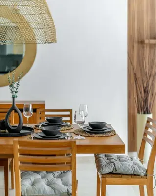 a dining room table with two chairs and a table with glasses at GuestReady - Lux home with sea view balcony in Dubai