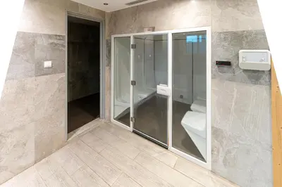 a bathroom with a glass shower and a toilet at Group Stay I Near Dubai Mall I Family friendly in Dubai