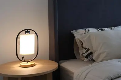 a lamp on a table next to a bed at Elite LUX Holiday Homes - Serene Golf View Living 1 BHK in Damac Hills, Dubai in Dubai