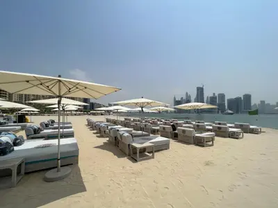 a bunch of umbrellas and chairs on a beach at Chic Palm Studio with Sea View & Infinity Pool in Dubai
