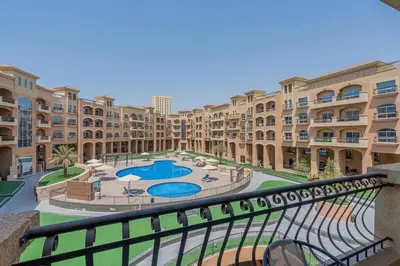 an apartment complex with a courtyard with two pools at Stunning 1 BR Apartment with Pool View in JVC Dubai in Dubai