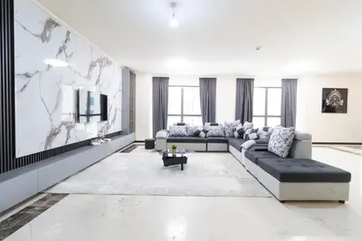 a living room with a couch and a tv at MURJAN JBR Apartments by HAPPY SEASON in Dubai