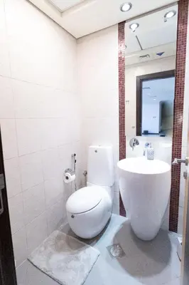 a bathroom with a white toilet and a sink at MURJAN JBR Apartments by HAPPY SEASON in Dubai