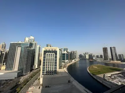 a view of a city with a river and buildings at Manzil - Cozy Studio nr Downtown w Canal Views in Dubai