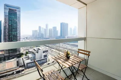 a balcony with a table and chairs and a city at Furnished Apartment for Rent in Saba 3, JLT in Dubai
