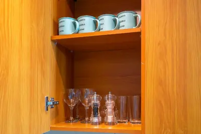 a cupboard with wine glasses and wine glasses at Furnished Apartment for Rent in Saba 3, JLT in Dubai