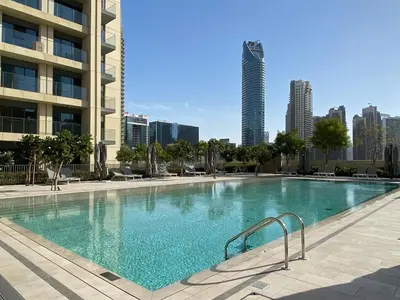 a large swimming pool with a city skyline in the background at Trophy - Downtown Skyview Residence in 35th floor in Dubai