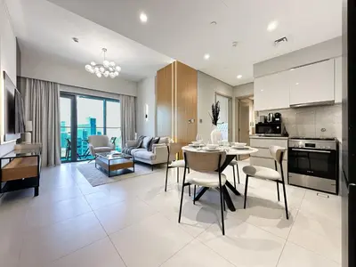 a kitchen and living room with a table and chairs at Trophy - Downtown Skyview Residence in 35th floor in Dubai