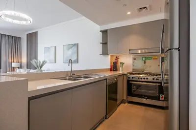 a kitchen with stainless steel appliances and a sink at Spacious 3BDR with Maid Room I Creek Harbour I Creek Gate Tower 2 in Dubai