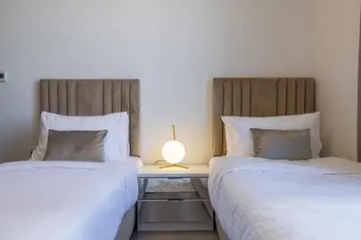 two beds sitting next to each other in a bedroom at Spacious 3BDR with Maid Room I Creek Harbour I Creek Gate Tower 2 in Dubai