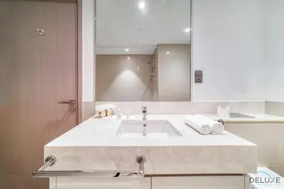 a bathroom with a sink and a large mirror at Plush 1BR at Act One Act Two Tower 2 Downtown Dubai by Deluxe Holiday Homes in Dubai
