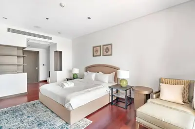 a bedroom with a bed and a couch and a chair at StoneTree - Anantara South Residences 2 BR - Palm Jumeirah in Dubai
