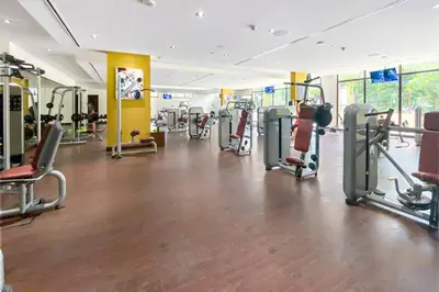 a gym with a lot of treadmills and machines at StoneTree - Anantara South Residences 2 BR - Palm Jumeirah in Dubai