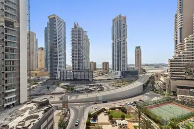 a highway in a city with tall buildings at StoneTree - Marina Tower 1BR - Dubai Marina in Dubai