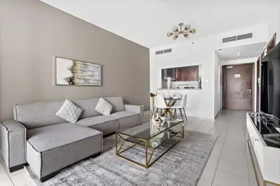 a living room with a couch and a table at StoneTree - Marina Tower 1BR - Dubai Marina in Dubai