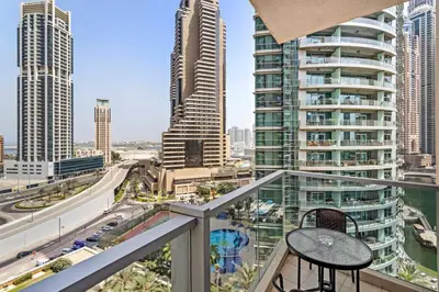 a balcony with a table and a view of a city at StoneTree - Marina Tower 1BR - Dubai Marina in Dubai