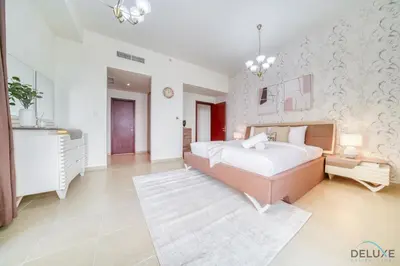 a large bedroom with a large bed and a table at Pristine 2BR at Bahar 2 JBR by Deluxe Holiday Homes in Dubai