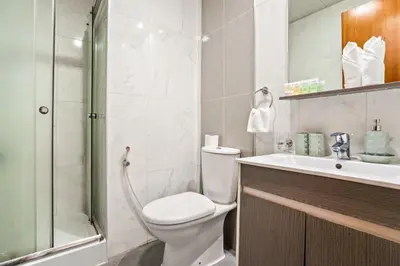 a bathroom with a toilet and a sink and a shower at Modern Silicon Oasis Studio Near Academic City in Dubai