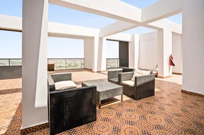a room with chairs and a table in a building at Modern Silicon Oasis Studio Near Academic City in Dubai