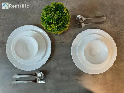 two white paper plates and forks on a table at Big Studio w/ Balcony and easy access to the Beach in Dubai