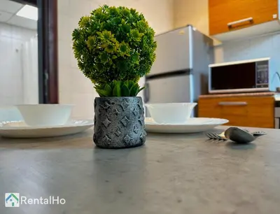 a vase with flowers on a counter in a kitchen at Big Studio w/ Balcony and easy access to the Beach in Dubai