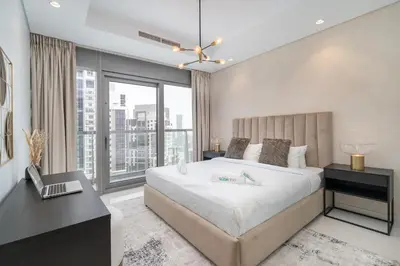 a bedroom with a large bed and a window at Stylish 2Bedroom w infinity pool on the 64th floor in Dubai