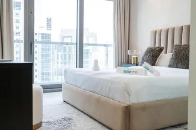 a large bed in a room with a large window at Stylish 2Bedroom w infinity pool on the 64th floor in Dubai