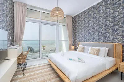 a bedroom with a large bed and a large window at Floral Charm studio in Damac Hills by Suiteable in Dubai