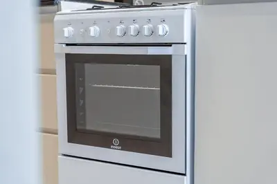 a white oven with a glass door in a kitchen at Floral Charm studio in Damac Hills by Suiteable in Dubai