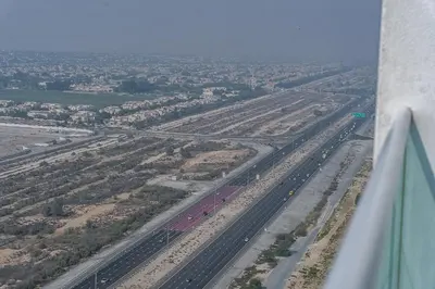 an aerial view of a highway from an airplane at Floral Charm studio in Damac Hills by Suiteable in Dubai