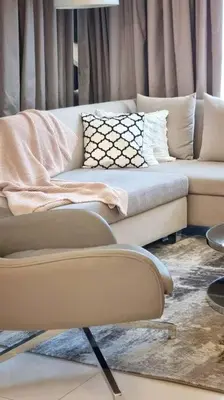 a living room with a couch and a chair at Luxury Paramount Hotel Apt D576 in Dubai
